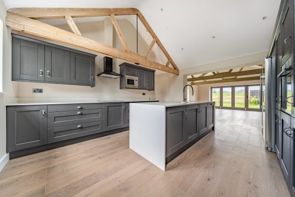 modern open plan kitchen with exposed beams and kitchen island