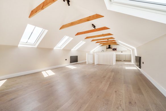 kitchen living space with exposed beams and rooflight windows