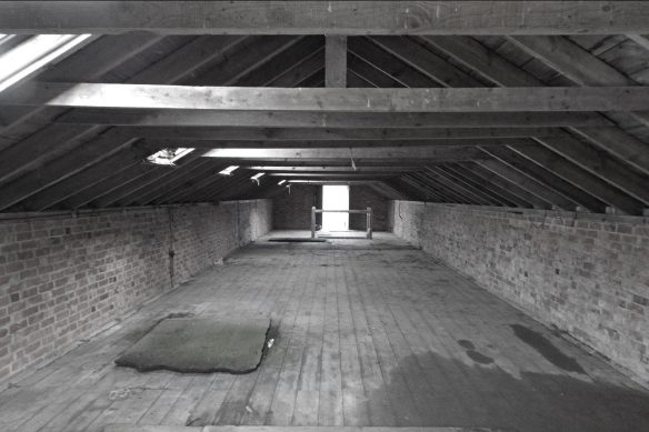 upstairs barn room before conversion with exposed beams