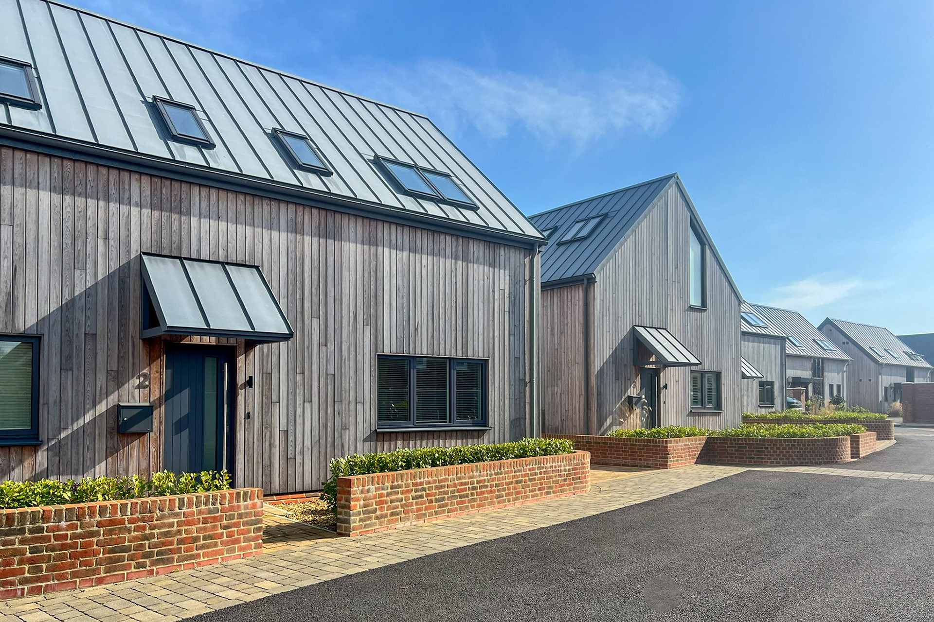 front gardens and entrance ways to new houses with wood panelled walls