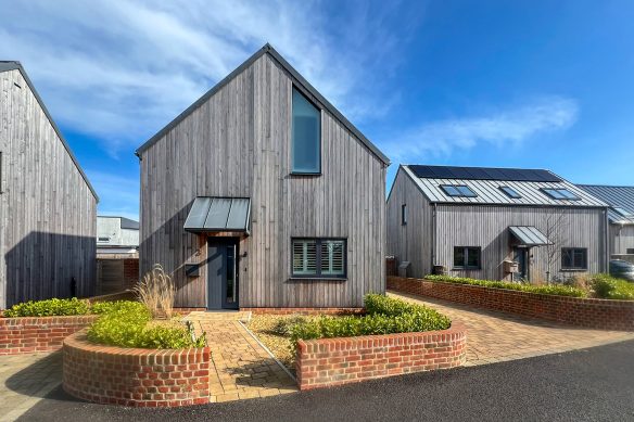 entrance to contemporary housing with timber panels and zinc roof