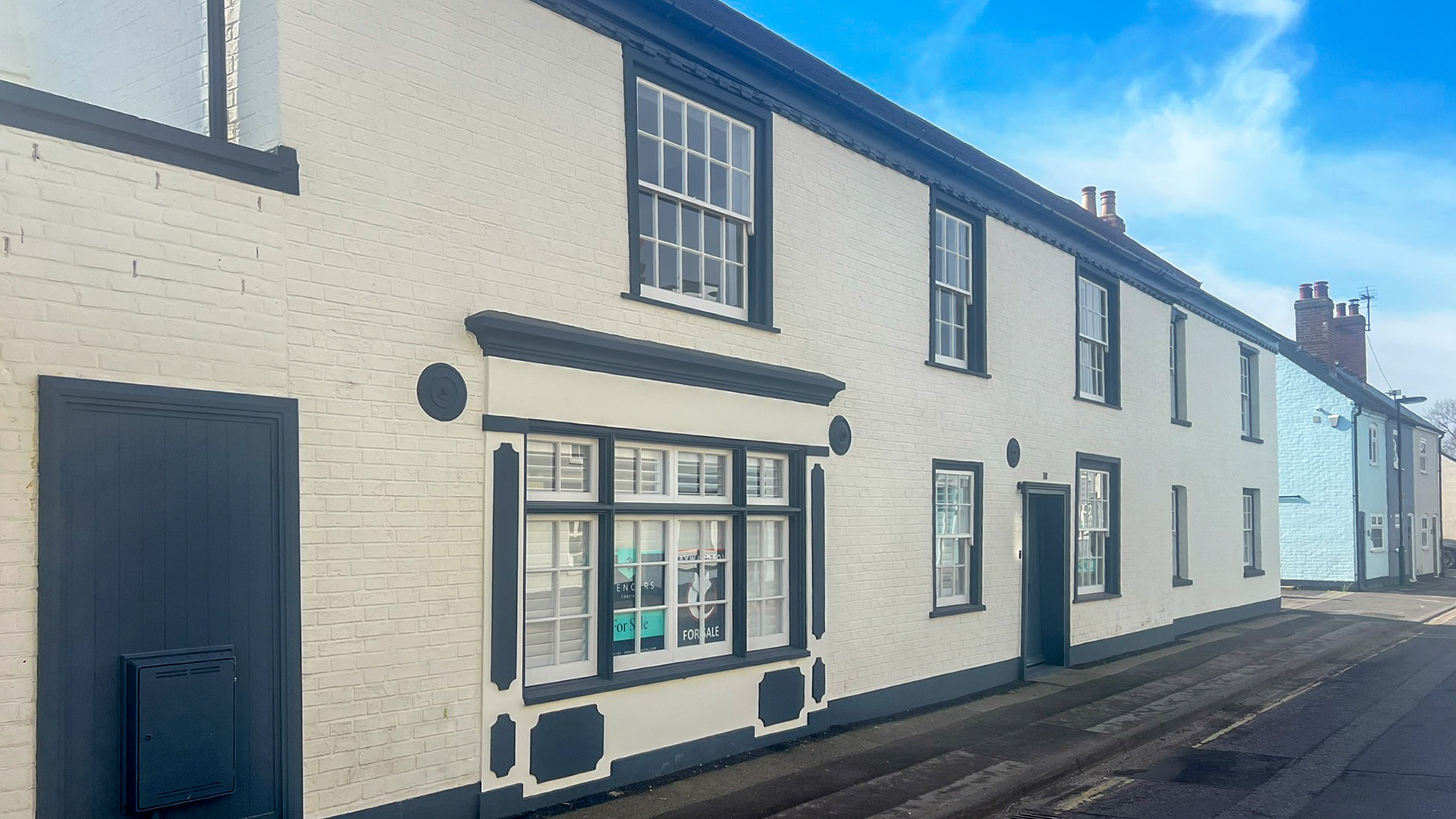 Front view of converted brick pub to residential house