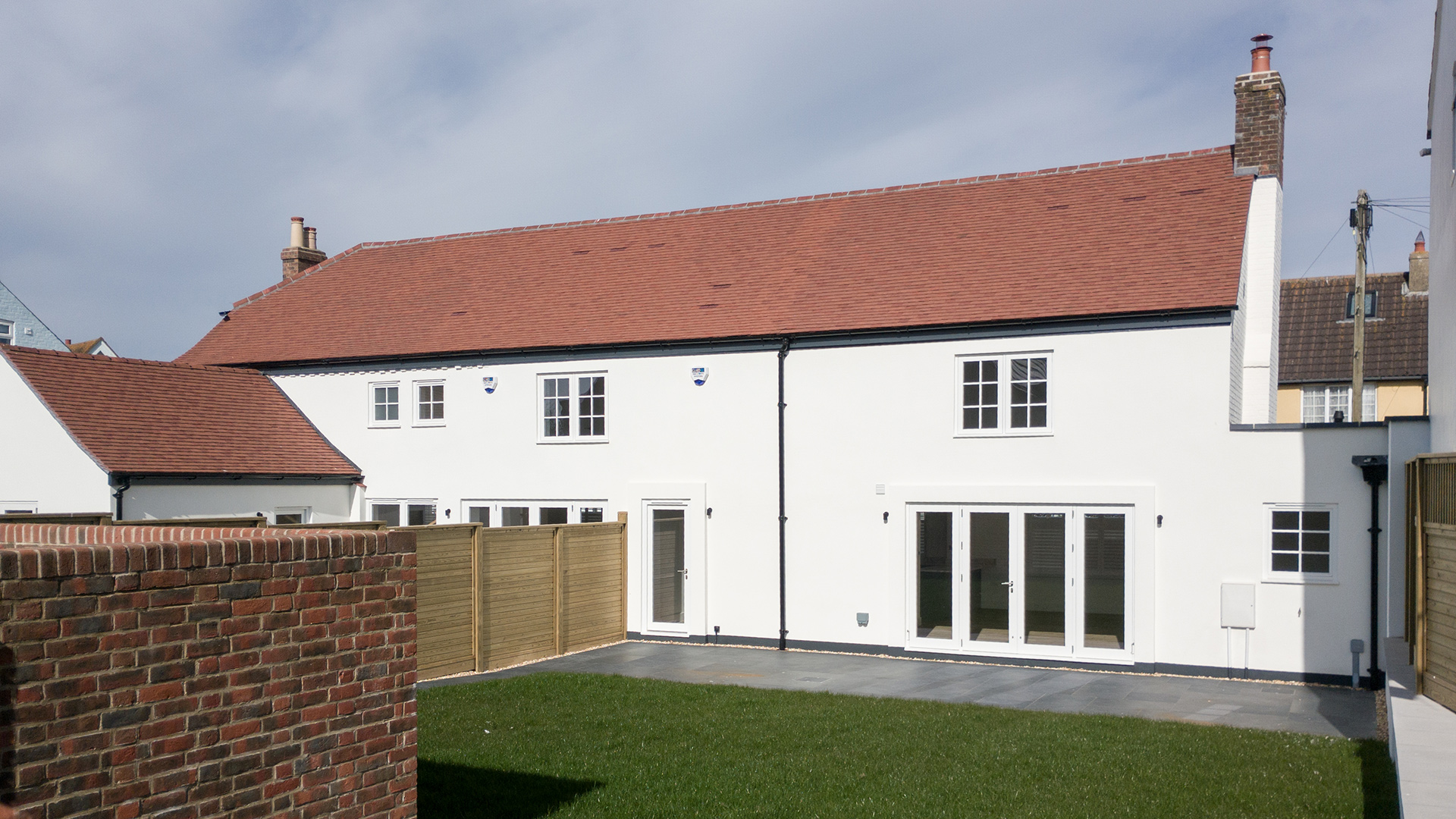 Rear view of white house and enclosed garden