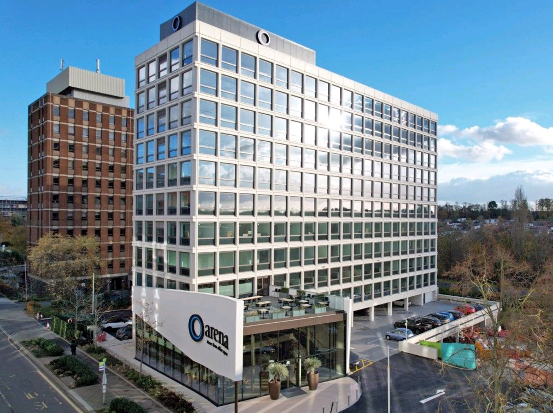 aerial photo of new office block building with car park on ground level