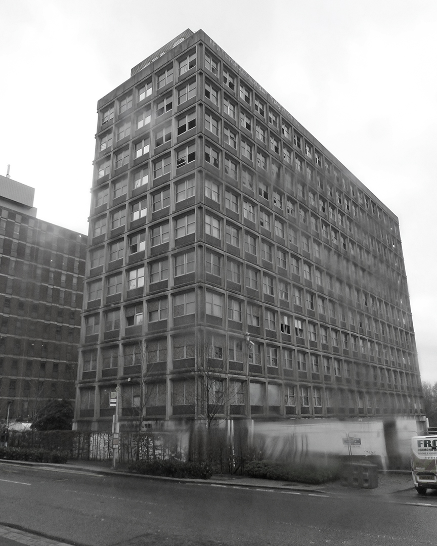 before photo of office block with boarded up windows