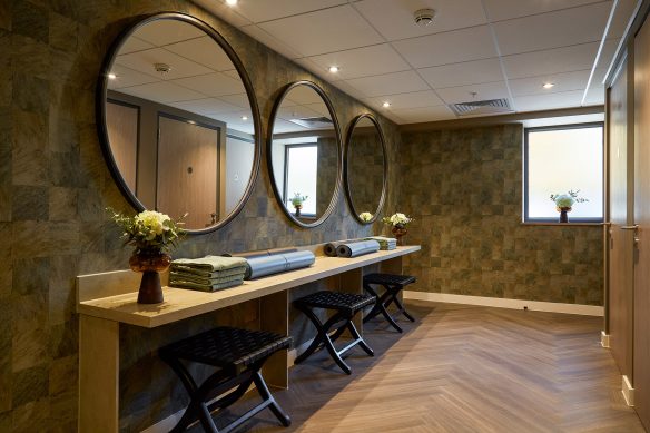 Changing room area with large circular mirrors