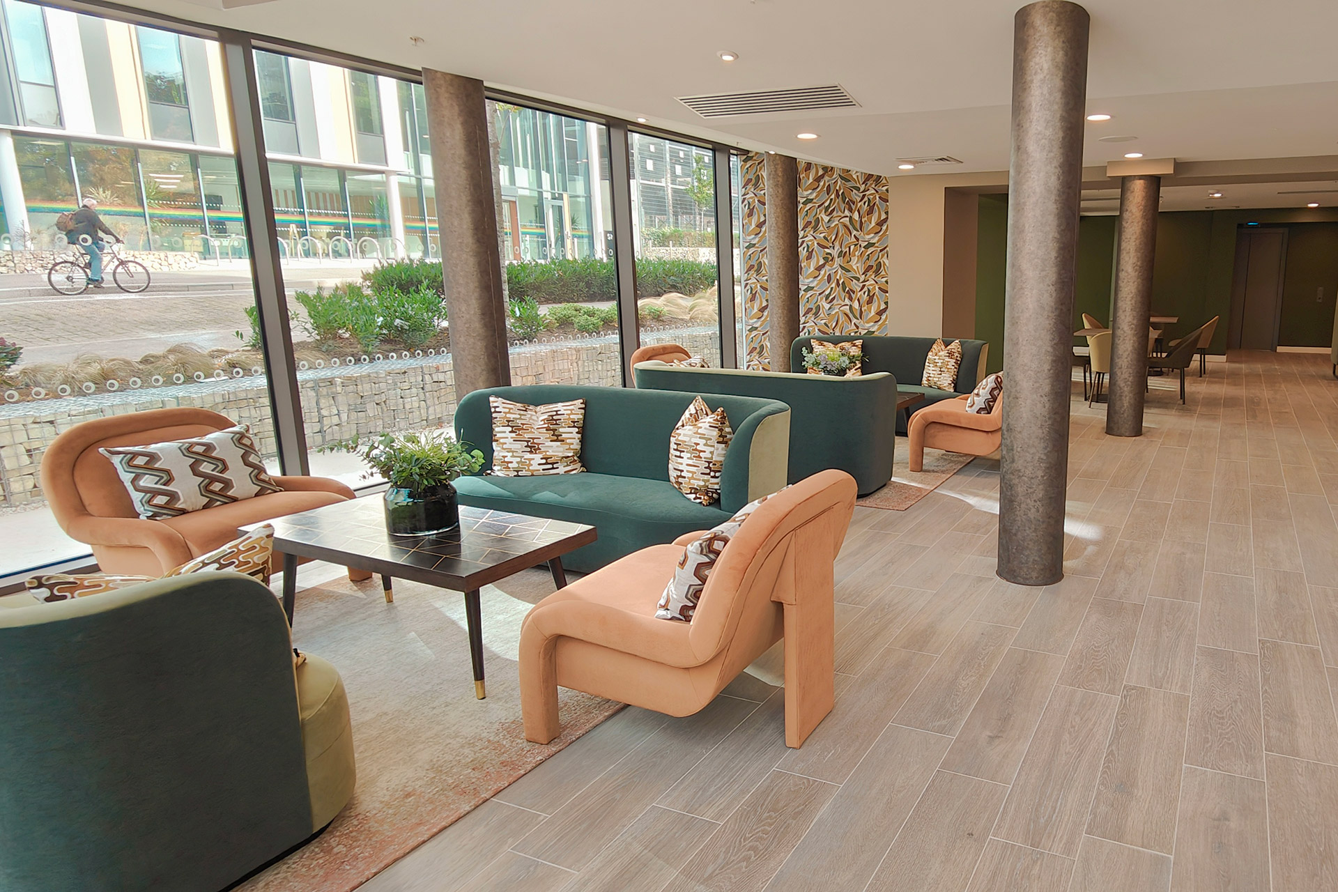 contemporary seating area in office block reception area with orange and blue sofas