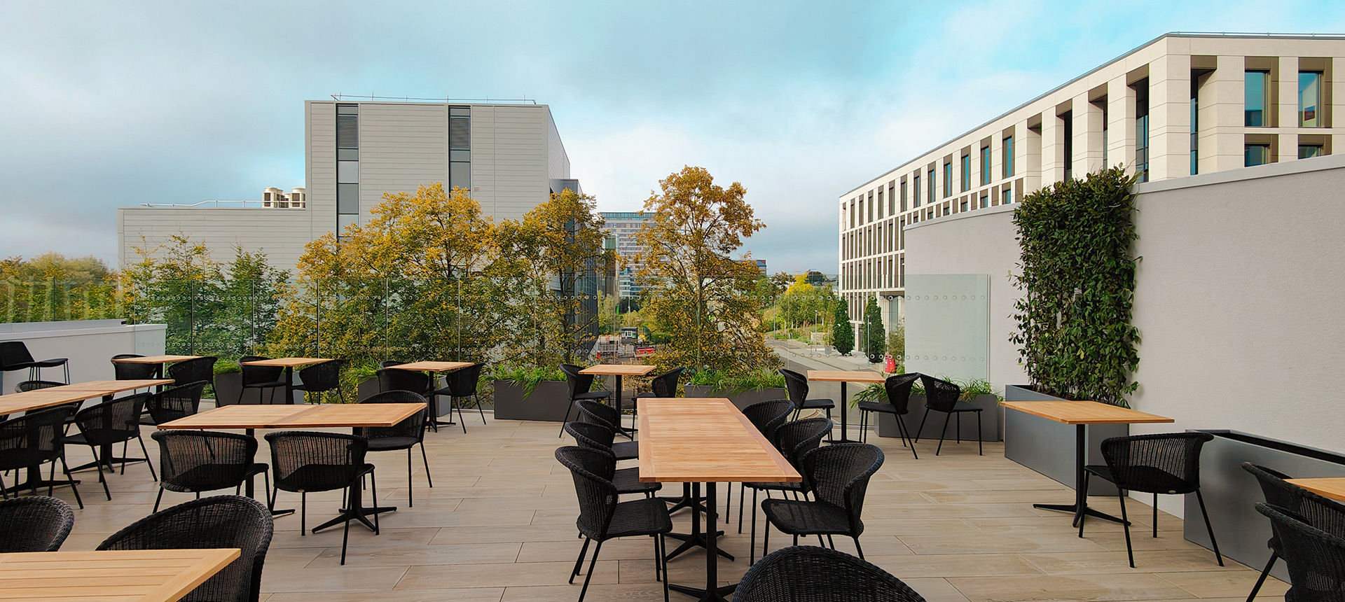 rooftop terrace with tables and chairs and city views