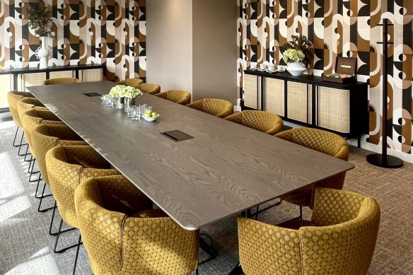 meeting room with large table and chairs with striking wallpaper