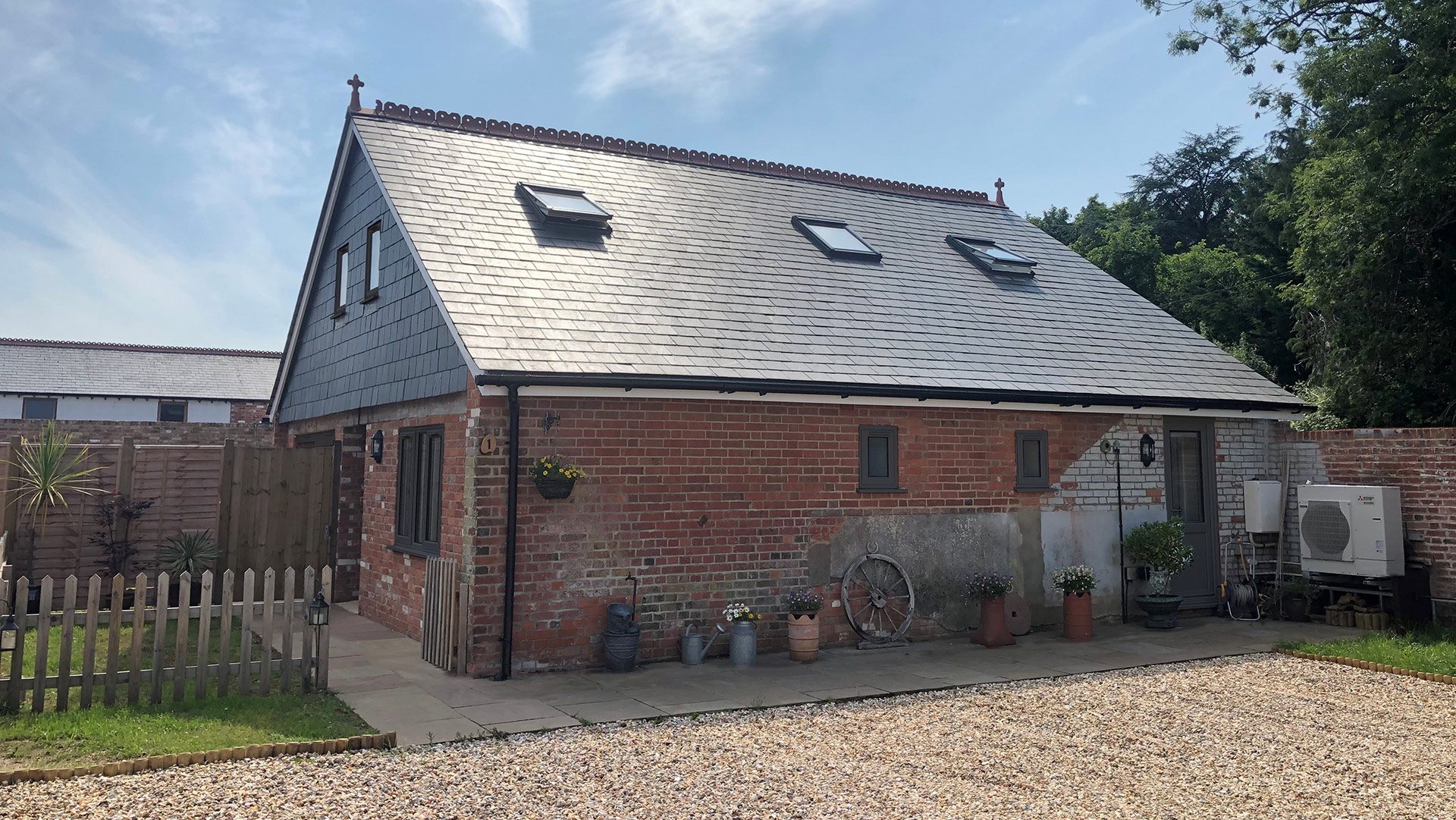class q red brick barn conversion with slate roof and skylights