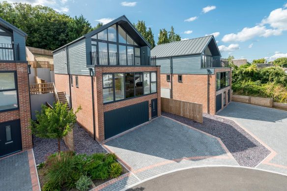 aerial view of detached houses with driveways