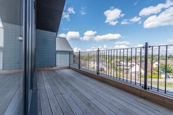 balcony on first floor of house with wooden floor and metal balustrade