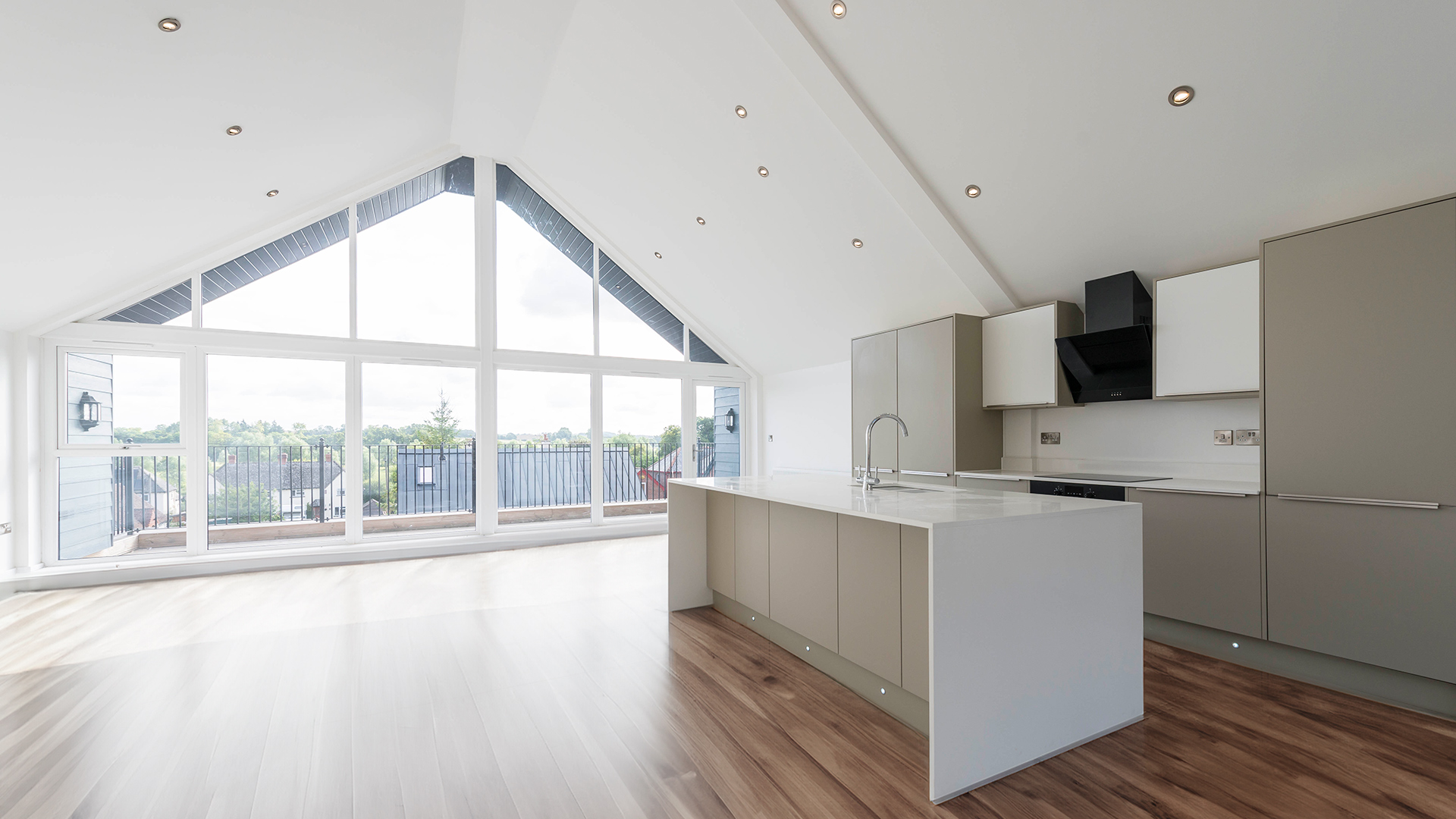 modern large open plan kitchen with island overlooking balcony