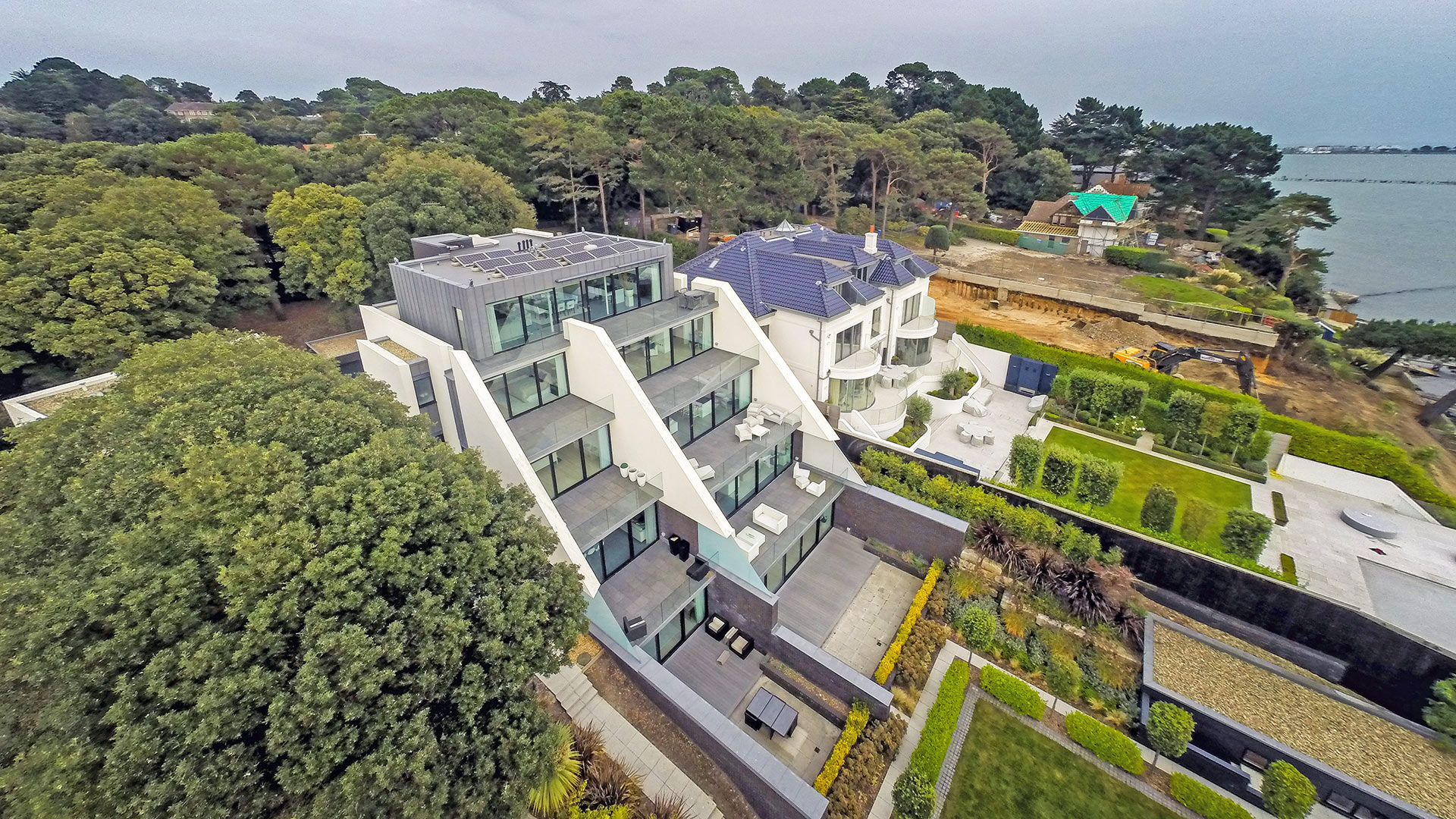 aerial view of large contemporary houses directly on the seafront
