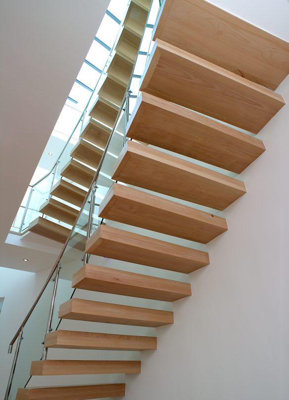 detailed photo of floating wood staircase with glass balustrade