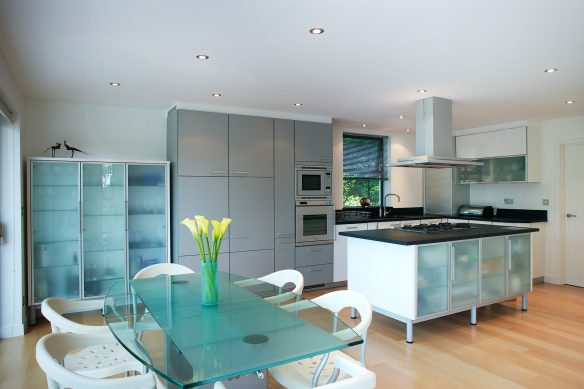 large modern neutral kitchen with kitchen island and dining table and chairs