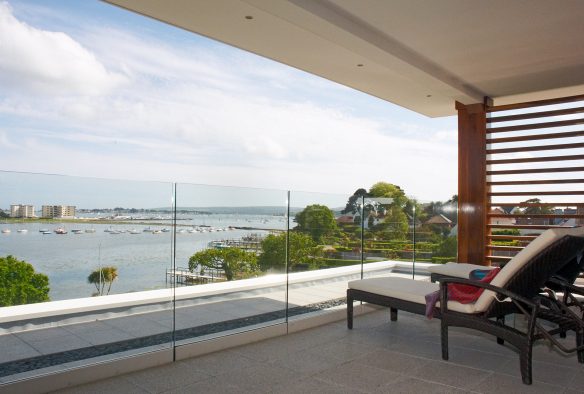 balcony with glass balustrade overlooking the sea and harbour