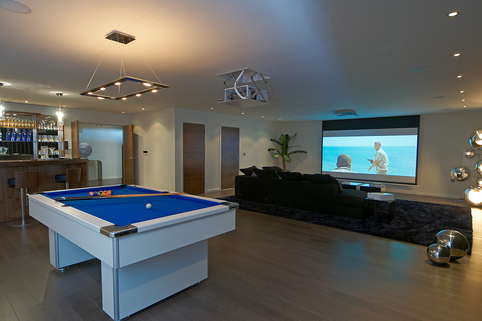 open plan entertainment area with projector and pool table
