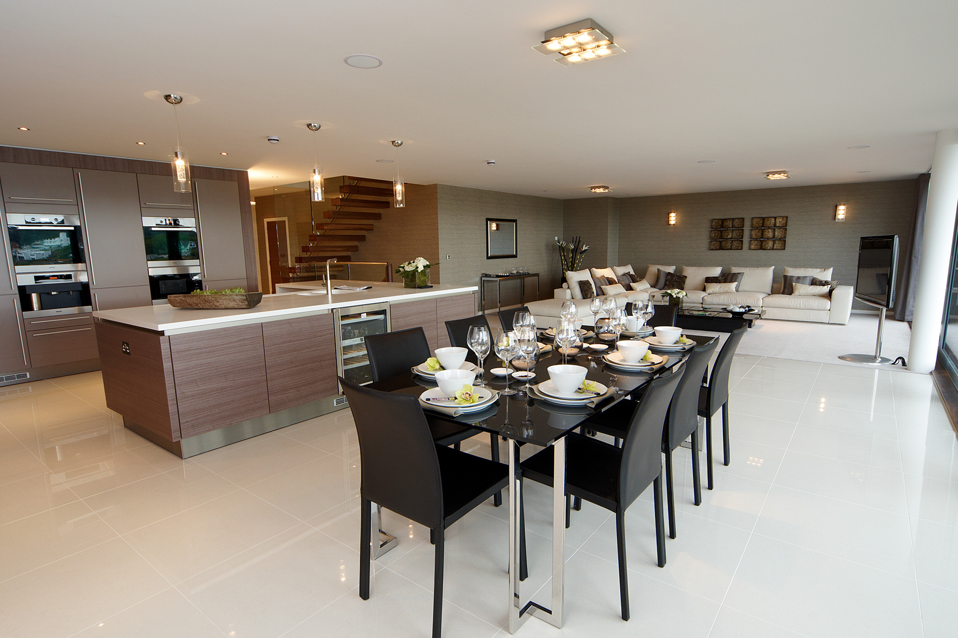 open plan kitchen living and dining area in grey and brown tones