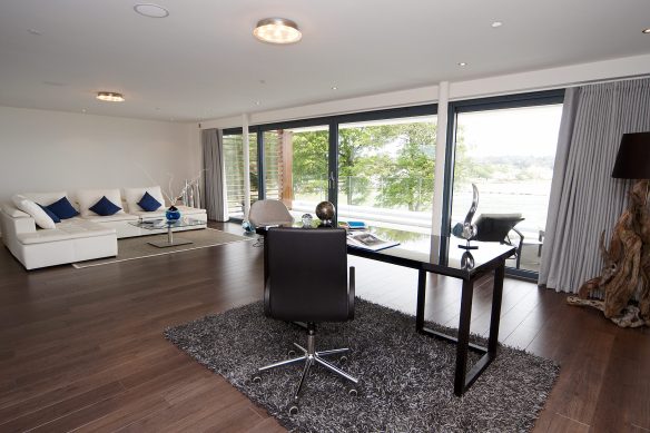 open plan study area with patio doors onto balcony