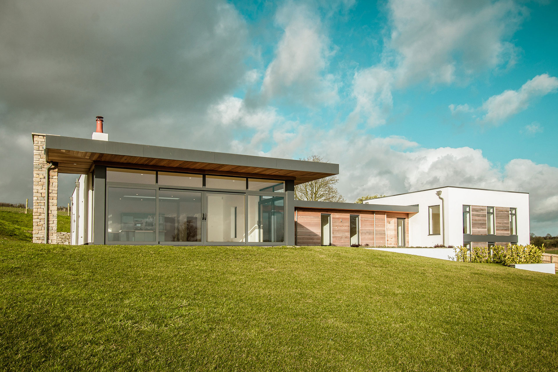 contemporary house with large windows and timber cladding