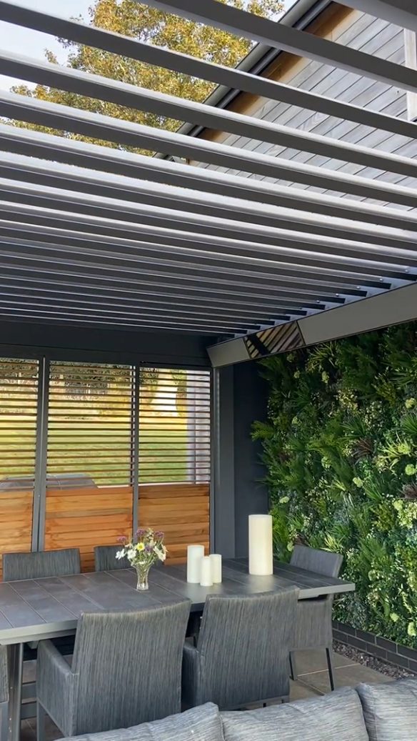 interior of garden room with plant wall and dining area