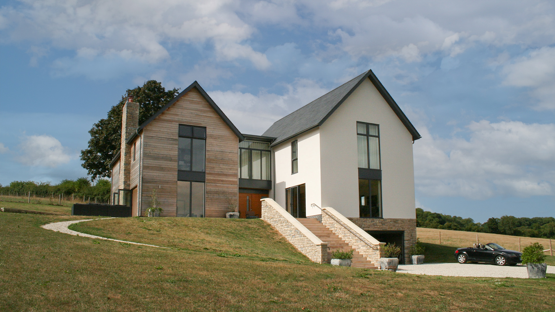 front view of contemporary house with stone staircase leading up to house