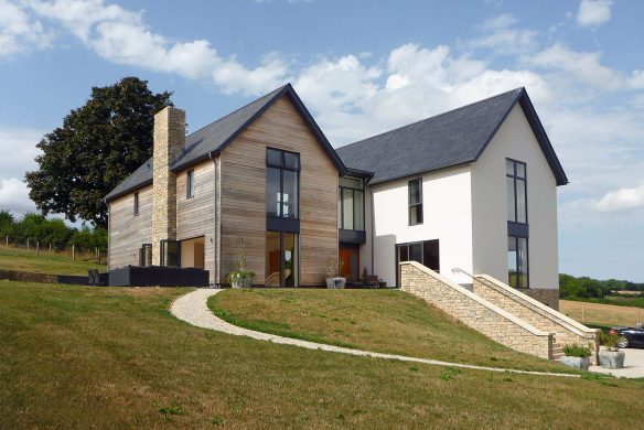 front and side view of contemporary house with stone staircase leading up to house