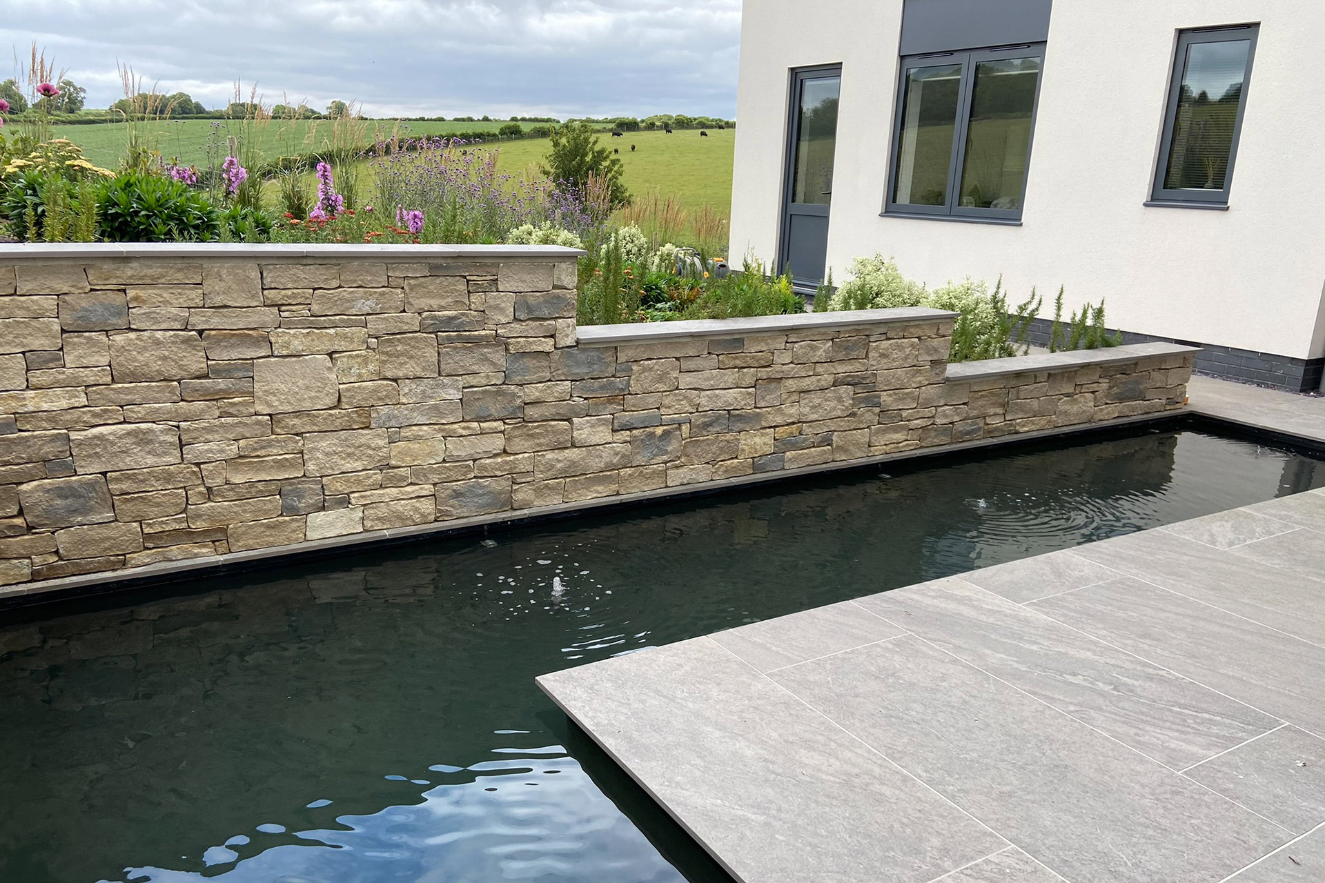 water feature in rear garden with stone wall
