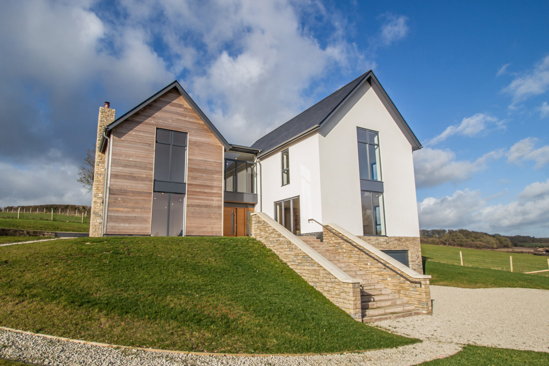 front view of contemporary house with stone staircase leading up to house