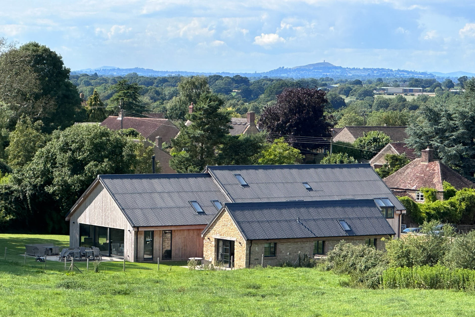 modern barn conversion in stone and timber cladding with beautiful countryside views