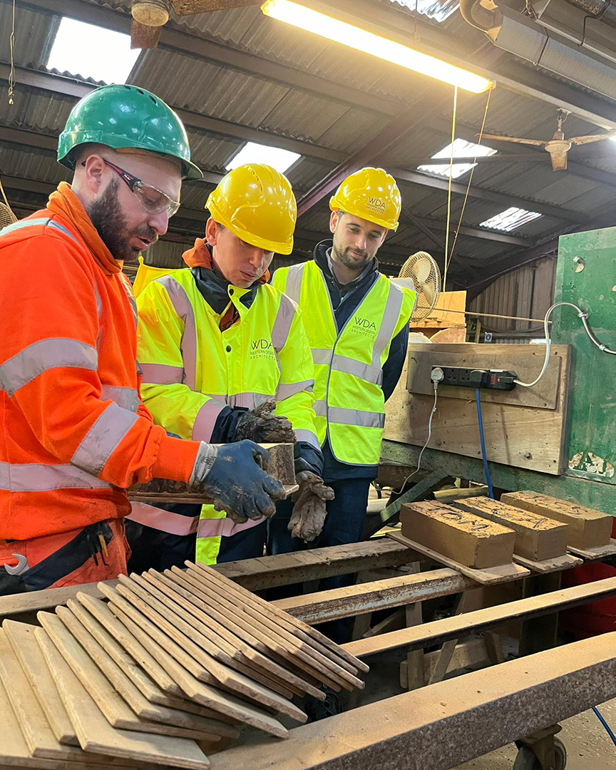 men learning how to make bricks