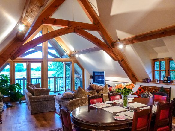 interior open plan living dining space with vaulted ceilings and exposed beams