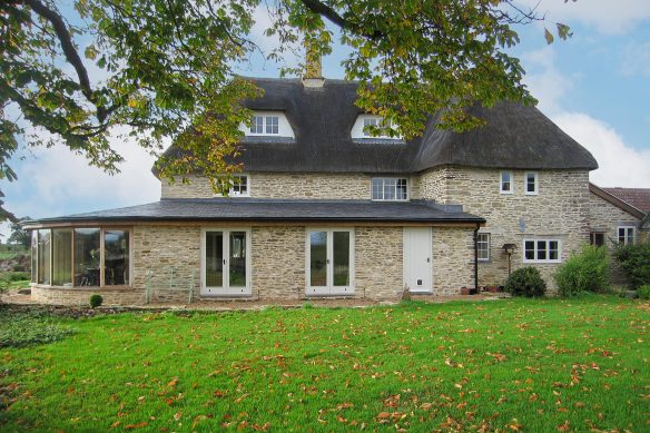 rear view of stone brick extension to thatched house