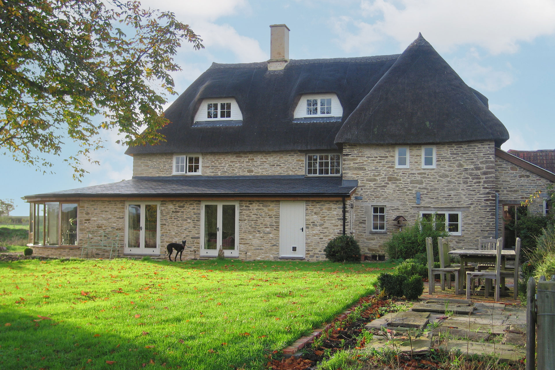 rear view of stone brick extension to thatched house