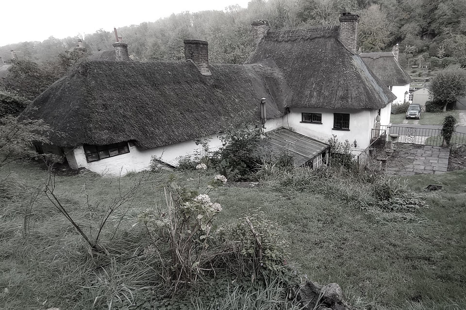 before photo of cottage with thatched roof