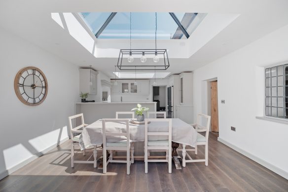 modern dining area in white with large rooflight