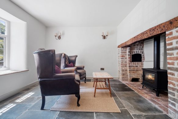 living area with log burner fireplace