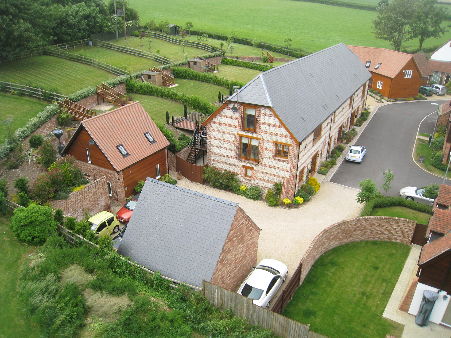 aerial view of farm houses with tiered back gardens