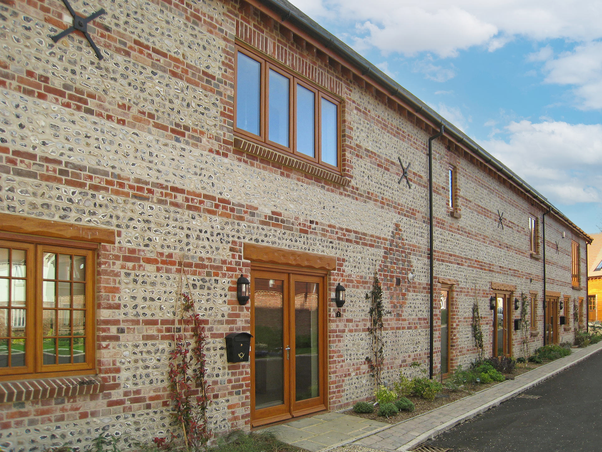 large barn conversion into terraced houses with stone walls