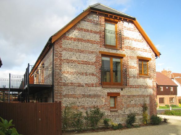 end of barn conversion wall with flint and brick