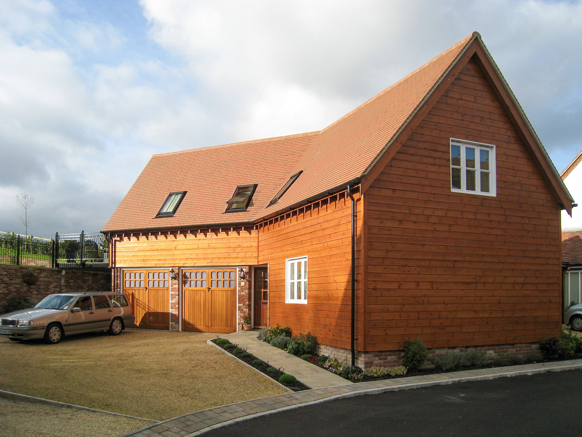 timber clad house with garage on first floor