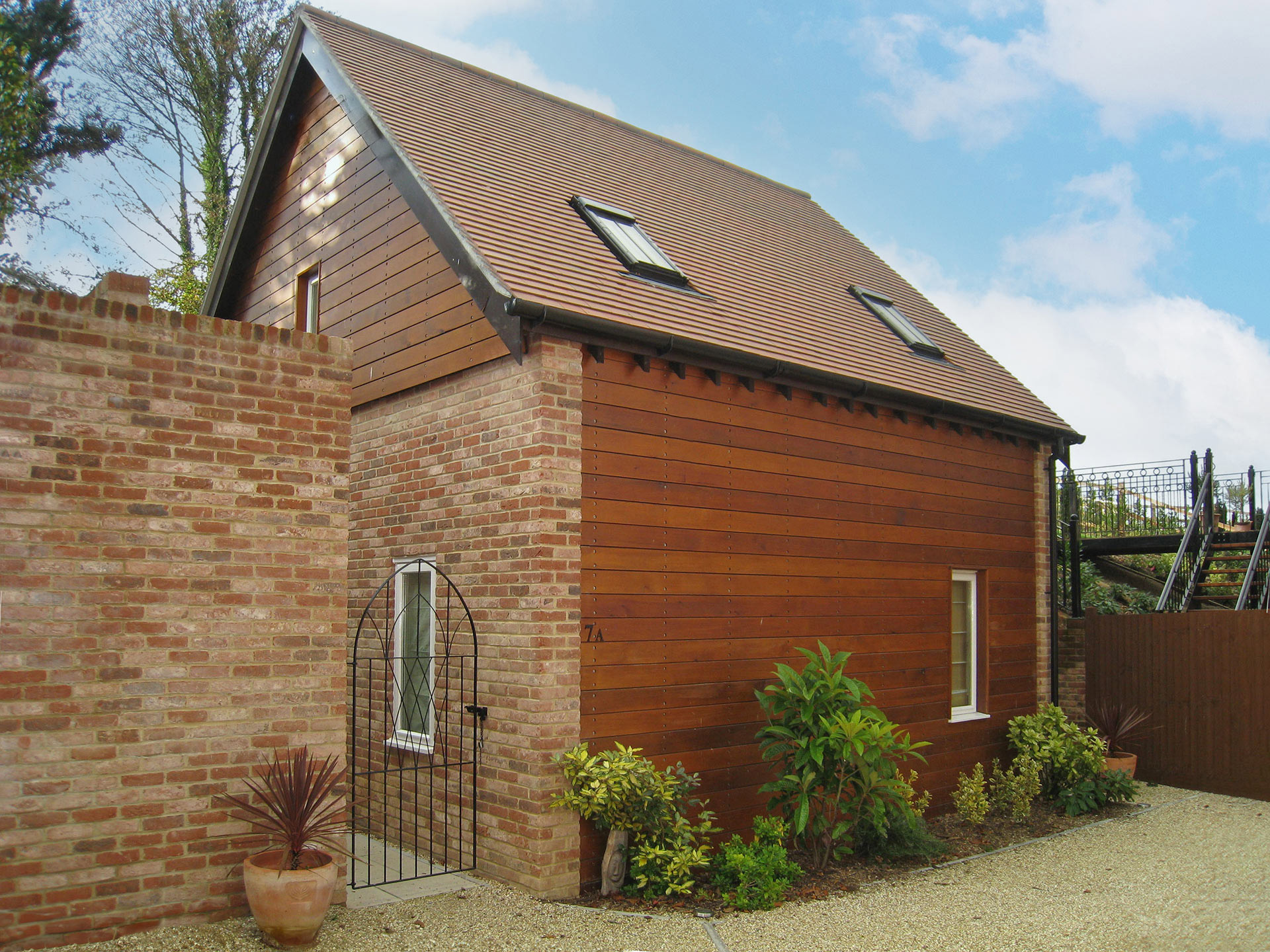 red brick and timber clad house with roof windows