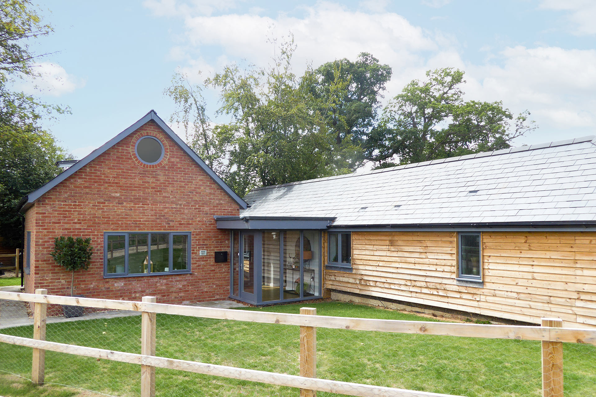 barn conversion and red brick extension with circular window