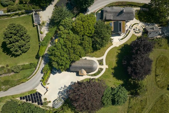 aerial of property including new house, landscaping and solar panels