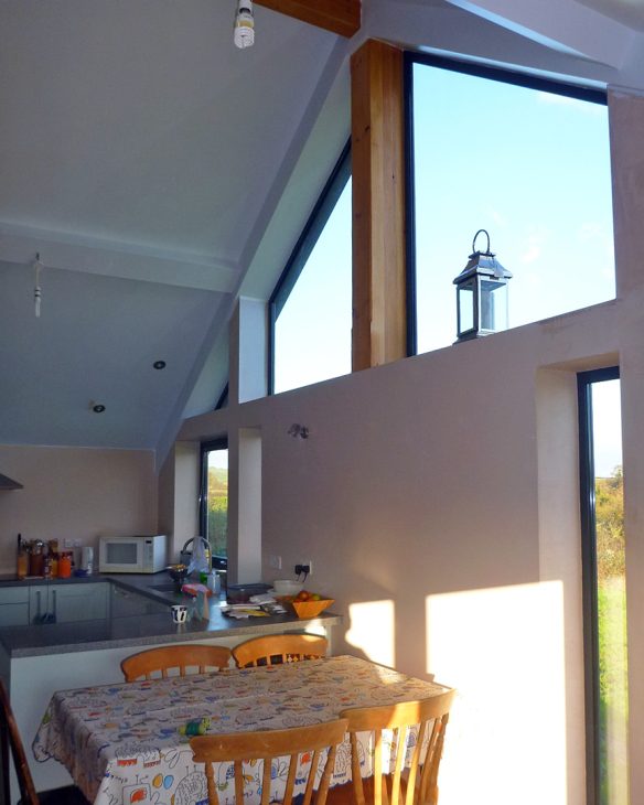 double height kitchen space with large windows