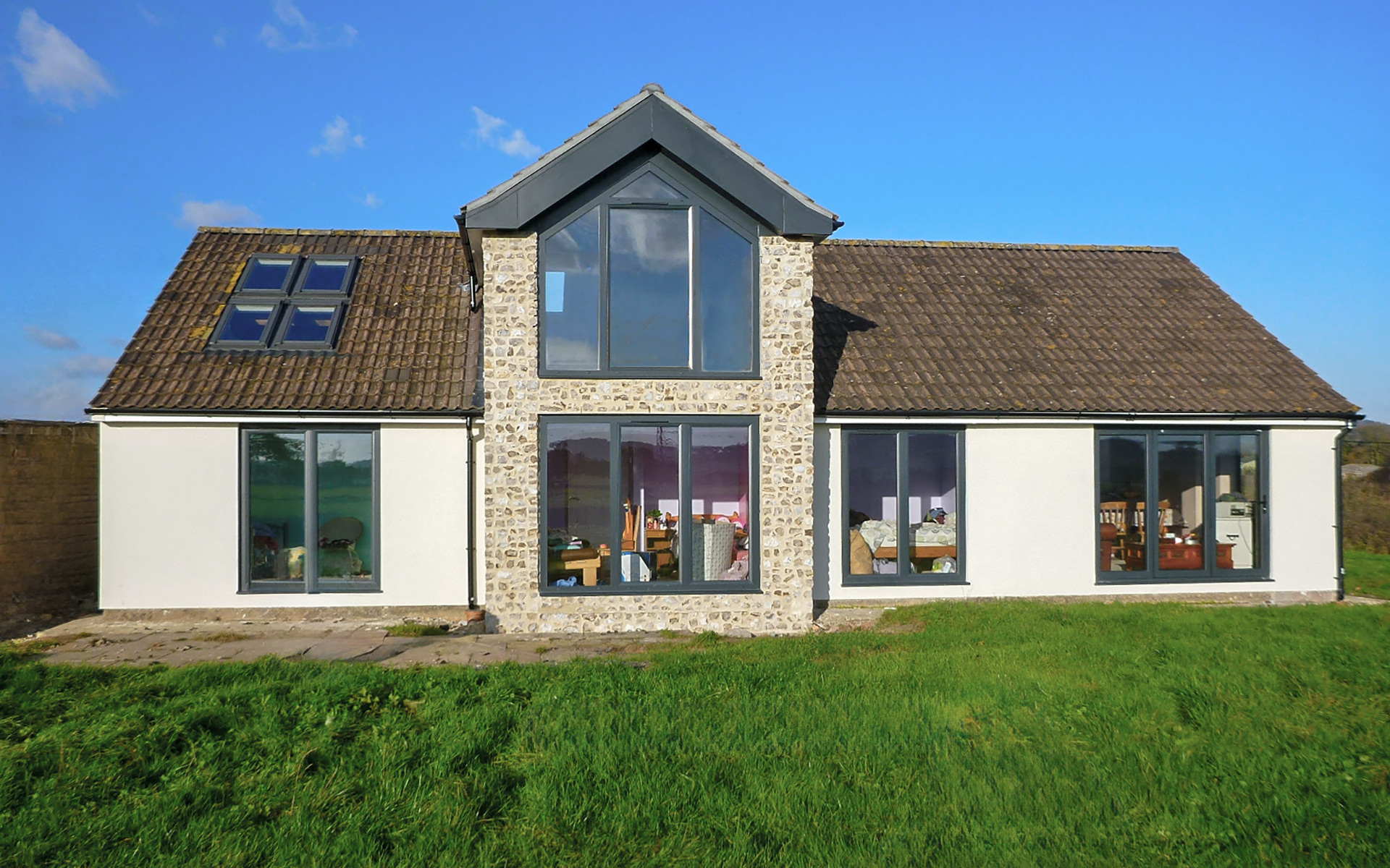 rear elevation of bungalow conversion with stone wall detail