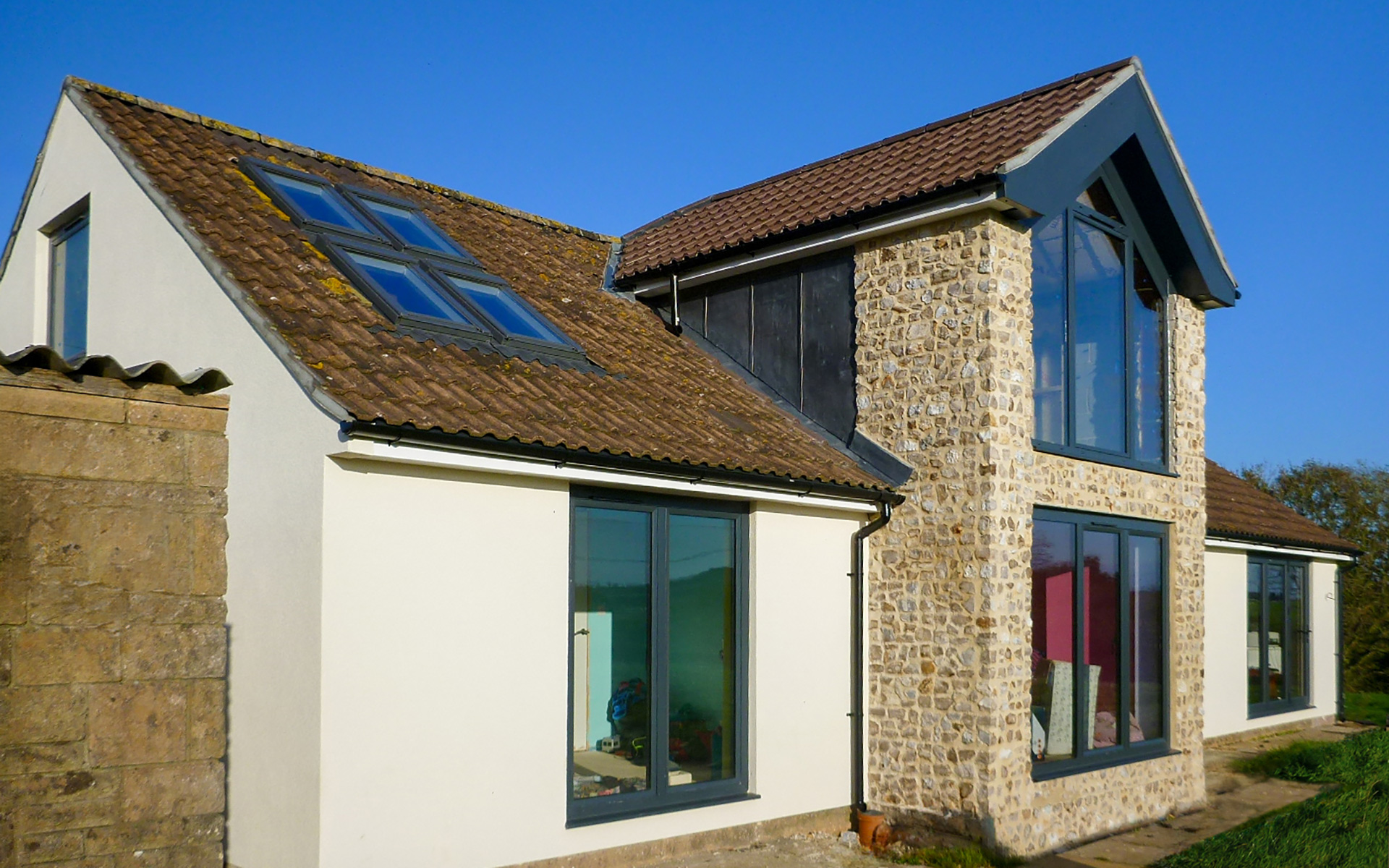 two storey extension with stone wall