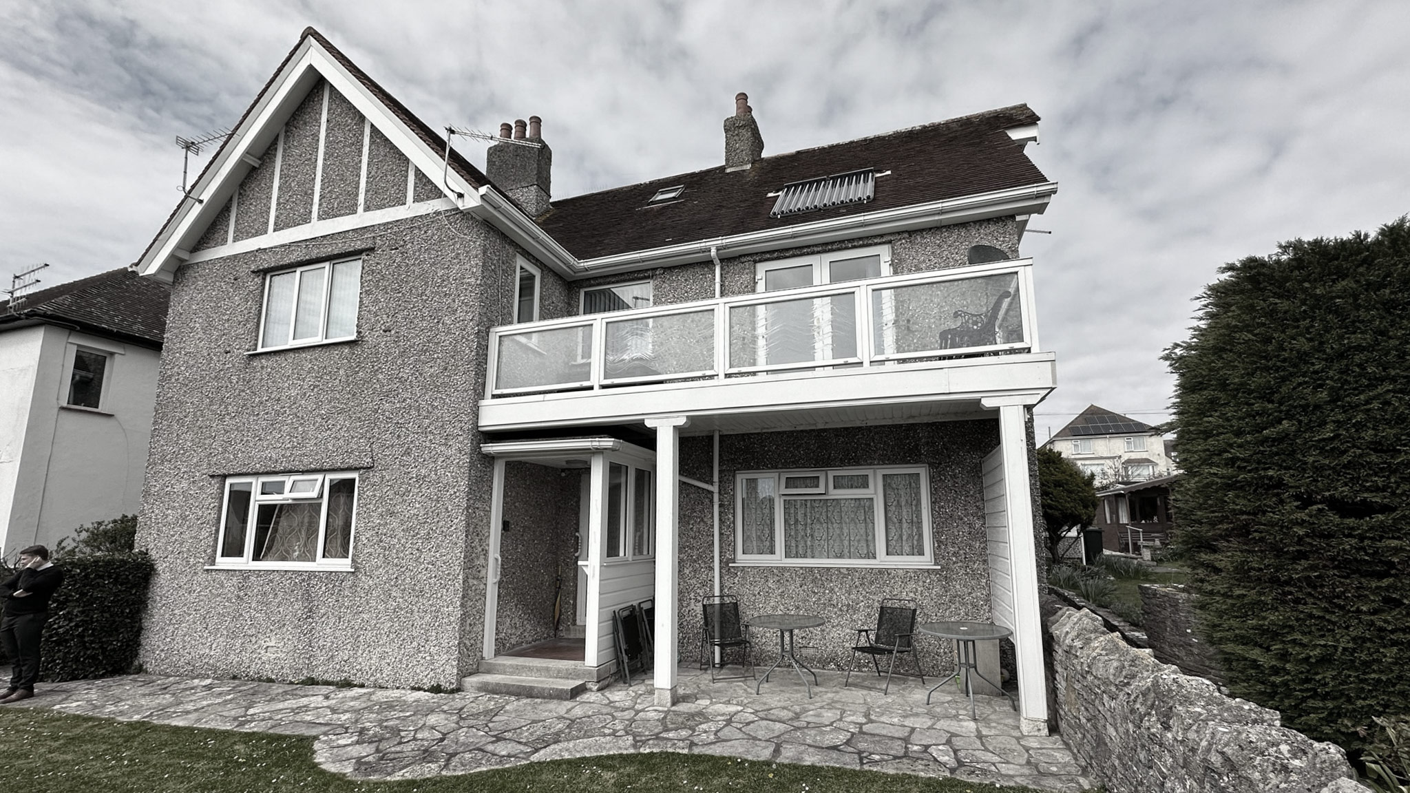 before photo of rear view of house with balcony