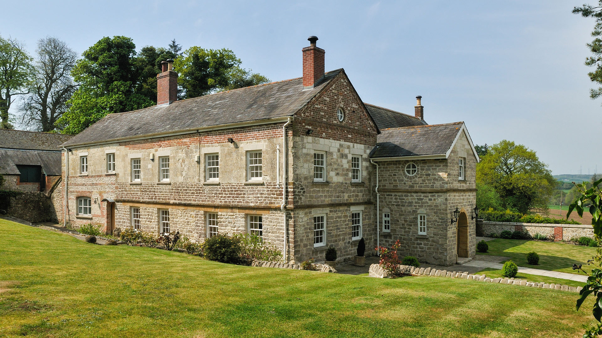 detail view of house with steps up to path leading to stone porch